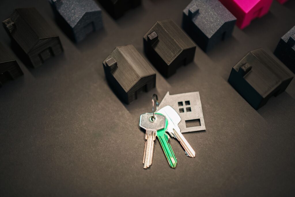Miniature house models and keys symbolize real estate investment and housing market.